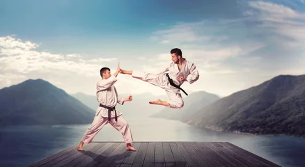 Foto op Plexiglas Vechtsport Vechtsporten, kick in jump, training op de pier