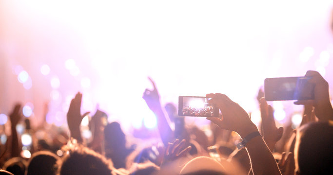 Fan taking photo of concert