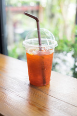 ice lemon tea on wooden table , coffee shop background