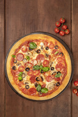 Pepperoni pizza on dark background with copy space