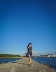 Beautiful woman walking near baltic sea