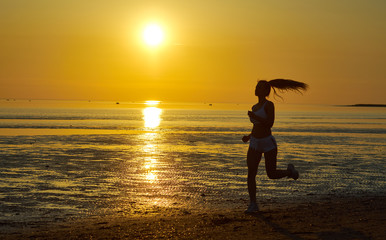 Fototapeta premium girl running by the sea on the beach