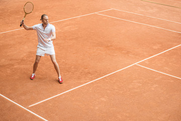 retro styled tennis player with racket on tennis court