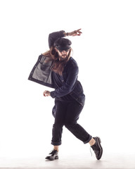 Young beautiful dancer is posing in studio