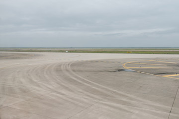 Empty airport runway on cloudy day
