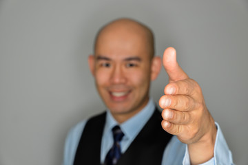 Blurred Businessman Offering Clear Handshake and Smile