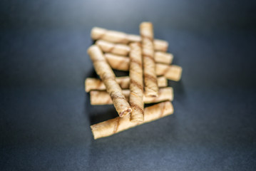 delicious cream filled wafers on the black background