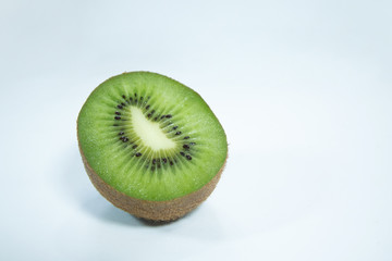 Fototapeta na wymiar close up perfect ripe slice kiwi green color and brown peel , organic fresh fruit on white , blue background