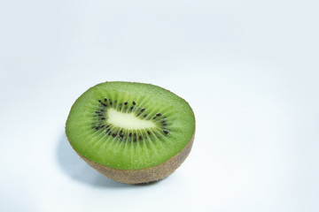 Naklejka na ściany i meble close up perfect ripe slice kiwi green color and brown peel , organic fresh fruit on white , blue background