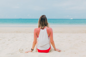 Woman in a bikini meditates on the sea. Lifestyle traveler