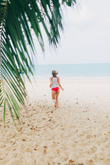 A woman in a bikini runs to the sea. Lifestyle traveler