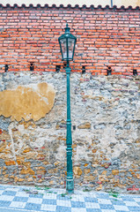 Old lantern on grunge brick wall background