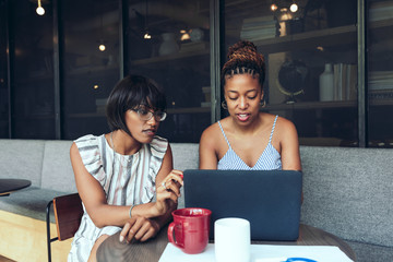 Businesswomen working on laptop while sitting in the office