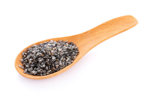 black sesame scrub seed in spoon isolated on white background