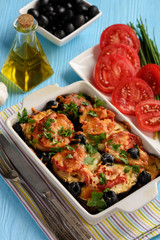 Eggplant casserole with mozzarella , tomatoes and olives.