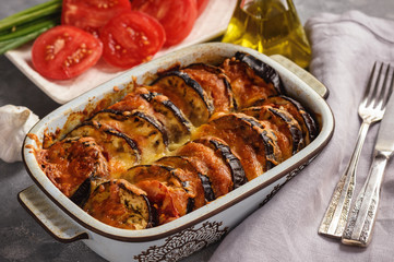 Eggplant casserole with mozzarella , tomatoes and olives.