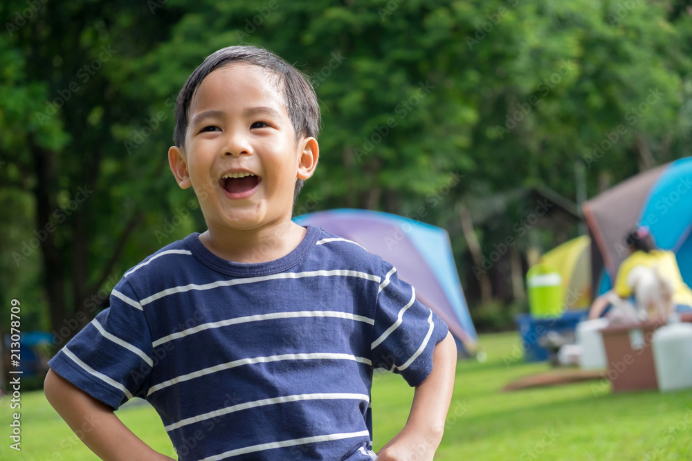 Wall mural happy cute asian boy stand and laugh at park