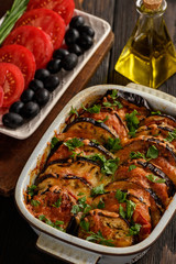 Eggplant casserole with mozzarella , tomatoes and olives.