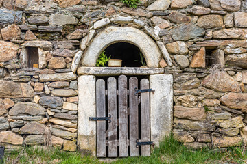 Wooden door on stone wall