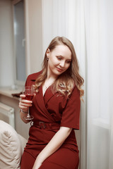 Attractive blond woman with a glass of red wine