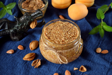 Fototapeta premium Urbech of apricot kernel in a glass jar. National Dagestani paste of nuts
