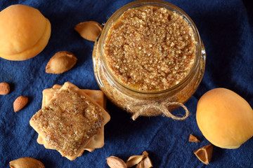 Urbech of apricot kernels in a glass jar and on a cracker