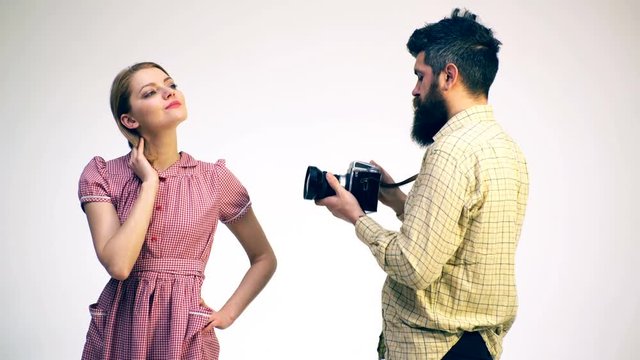 Photographer takes a model on the studio on a white background. Concept of studio photography.