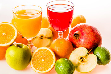 Ripe fruit and juice. Glasses of juice and fruits isolated on white.