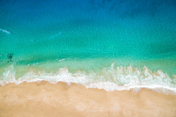 Ocean tide rolling up on sandy shore