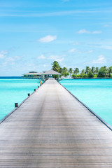 Obraz premium Pier at Maldives. Blue water, boats. Summer holidays photo.