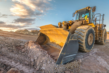 Bulldozer on roadside of unpaved highway