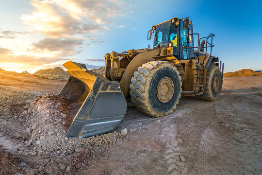 Bulldozer on roadside of unpaved highway