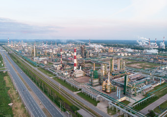 Oil refinery plant industry, Refinery factory, oil storage tank and pipeline steel with sunrise and cloudy sky background, Russia