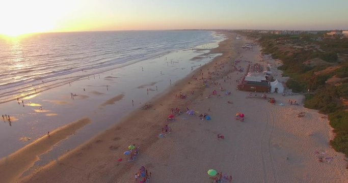 Aerial - Beatiful beach with sun umbrellas and beach restaurant
