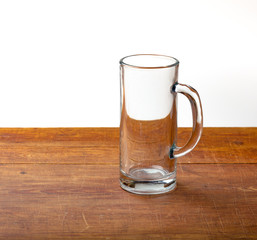 large empty pint of beer on old wooden table