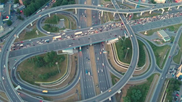 flight of the camera over the traffic junction. Aerial top view of road junction in Moscow from above, automobile traffic and jam of many cars, transportation concept.