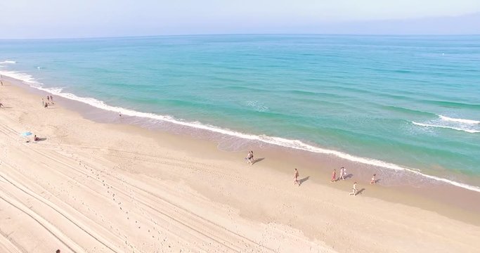Aerial - Beatiful beach with sun umbrellas and beach restaurant