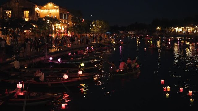 Hoi An, Vietnam - May 10, 2018: Night river Thu Bon view with floating lanterns and boats. Hoi An, once known as Faifo. Hoian is a city in Vietnam and noted as a UNESCO World Heritage Site.
