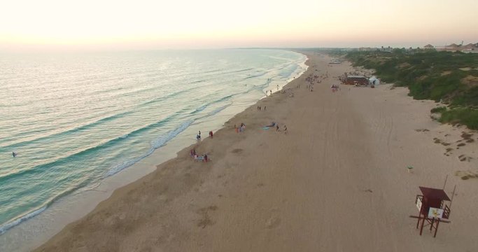 Aerial - Beatiful beach with sun umbrellas and beach restaurant