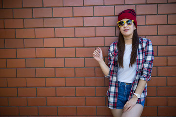 Portrait asian hipster girl on brick wall background,Lifestyle of thailand people