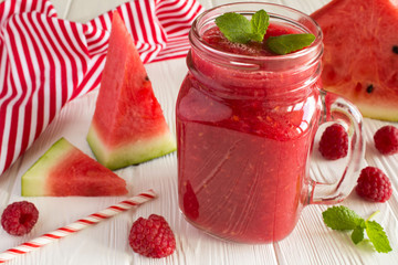 Smoothies from watermelon and raspberries on the white wooden background