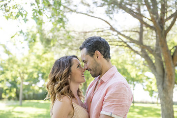 man and woman posing in the park