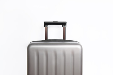 Suitcase on light grey background with place for text. Minimal creative travel concept