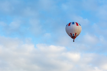 Hot air balloon under blue sky.