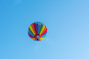 Hot air balloon under blue sky.