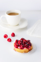 Tartlets with raspberries and a cup of green tea