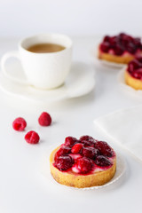 Tartlets with raspberries and a cup of green tea