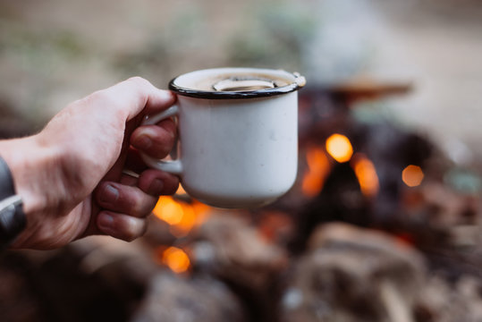 Hands Holding Cup Of Tea The Outdoors. Adventure, Travel, Tourism And Camping Concept. Hiker Drinking Tea From Mug At Camp