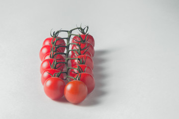 branch of fresh tomatoes cherry on a white background