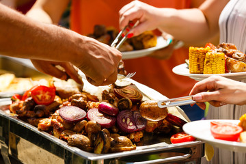 Cuisine Culinary Buffet Dinner Catering Dining Food Celebration Party Concept. Group of people in all you can eat catering buffet food indoor in luxury restaurant with meat and vegetables.